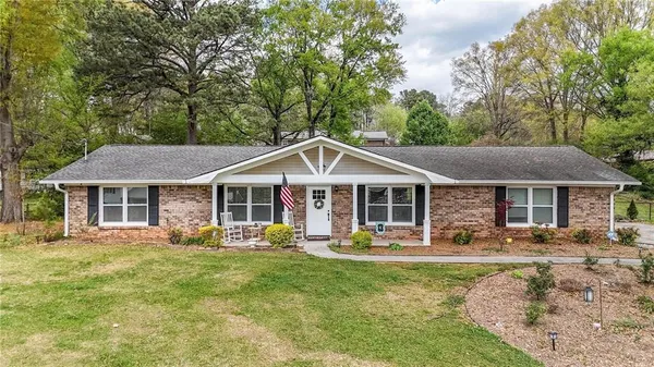 a front view of a house with a yard patio and fire pit