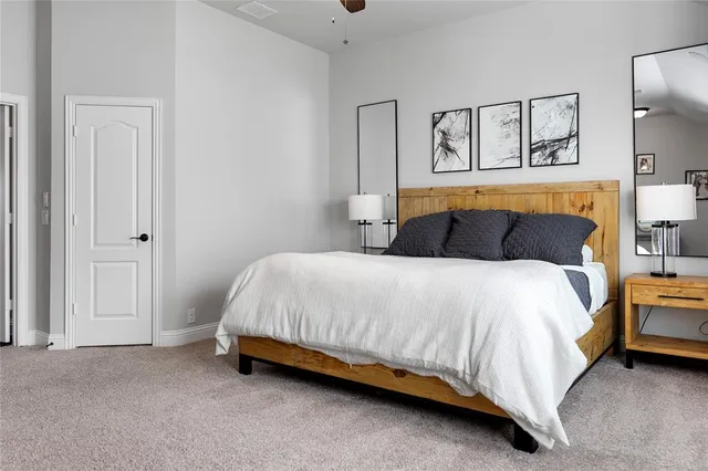 a bedroom with a bed and lamp