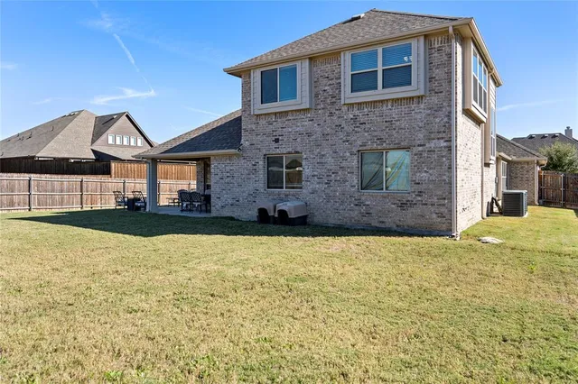 a backyard of a house with outdoor seating