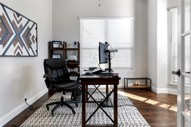 a view of a workspace with furniture and a window