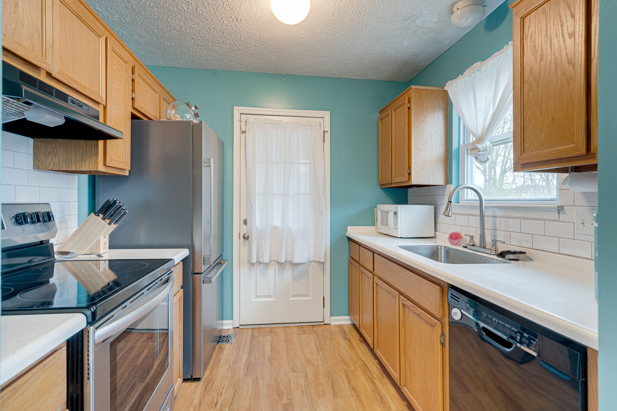 1453 Ocoee Trail Madison, TN 37115 - Photo 11 of 25 a kitchen with a sink cabinets stainless steel appliances and a window