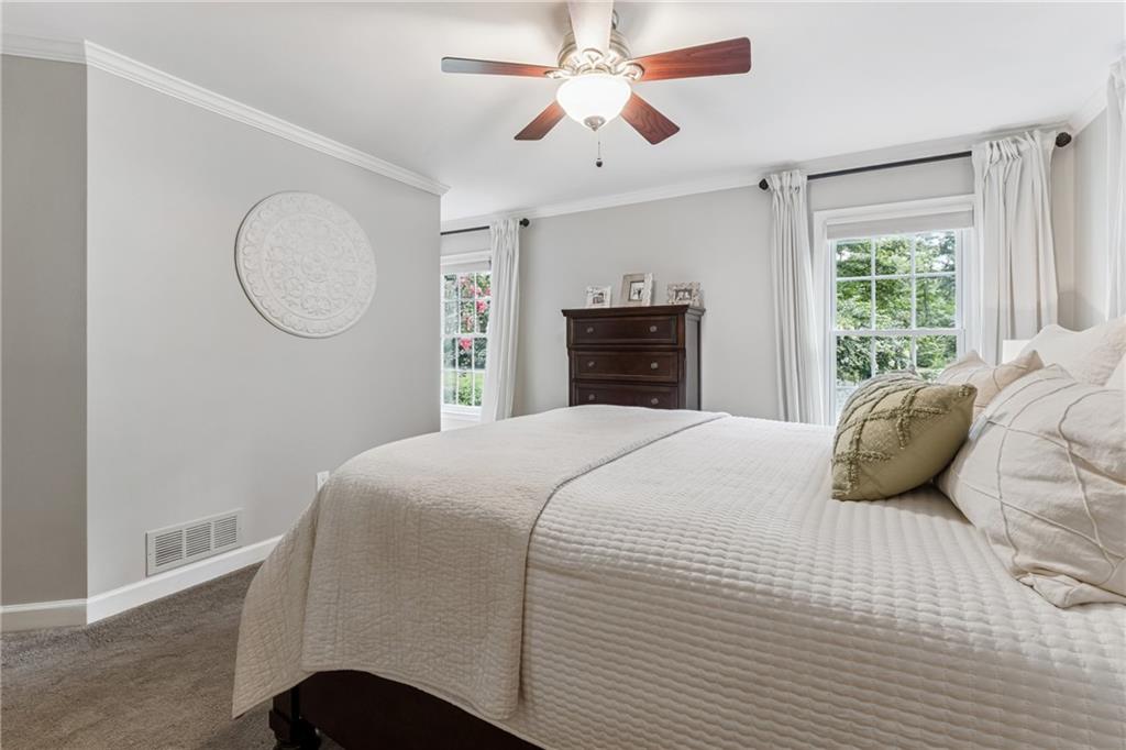 3701 Shallowford Road Marietta, GA 30062 - Photo 23 of 49 a bedroom with a bed and a chandelier