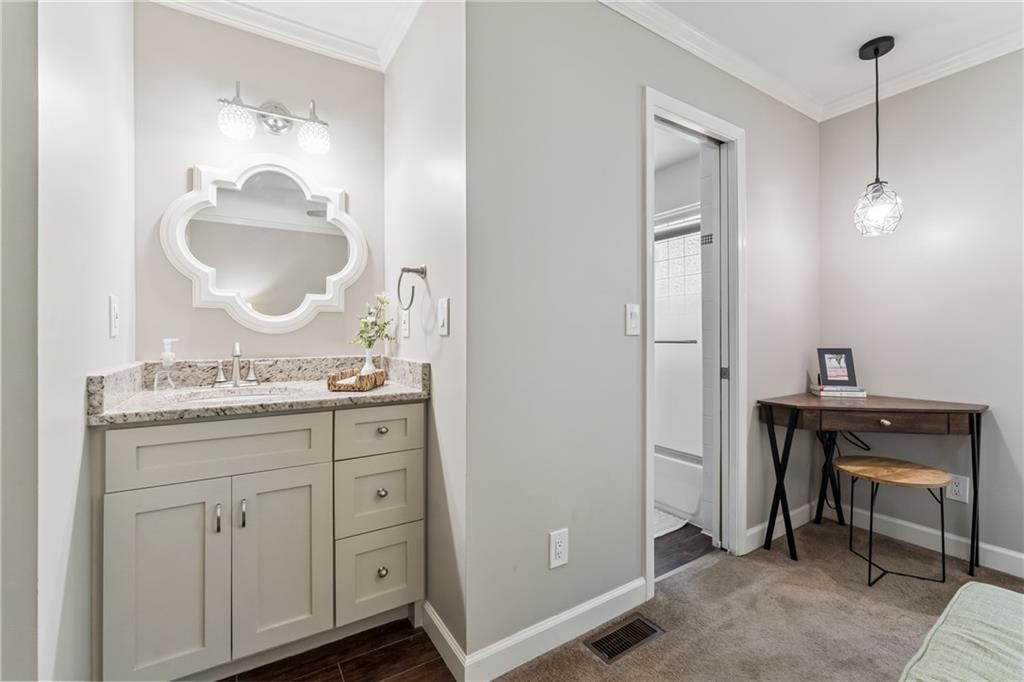 3701 Shallowford Road Marietta, GA 30062 - Photo 31 of 49 a en suite bathroom with a granite countertop sink a mirror and a vanity
