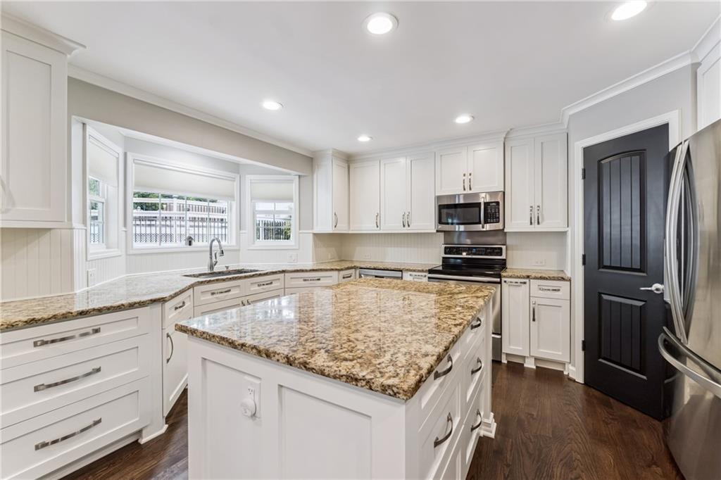 3701 Shallowford Road Marietta, GA 30062 - Photo 6 of 49 a kitchen with kitchen island granite countertop a stove sink and refrigerator