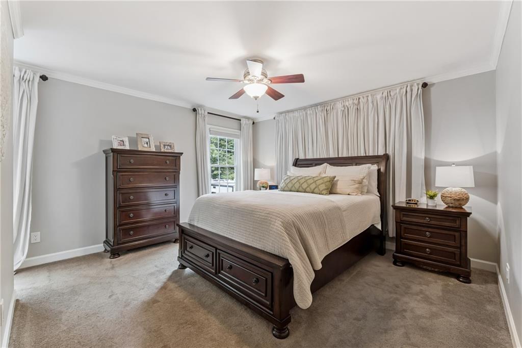 3701 Shallowford Road Marietta, GA 30062 - Photo 8 of 49 a spacious bedroom with a bed and a chandelier