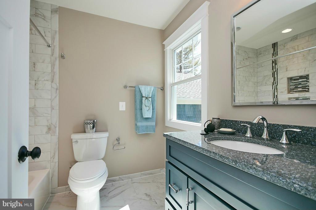 1871 Beulah Road Vienna, VA 22182 - Photo 18 of 30 a bathroom with a toilet sink and mirror