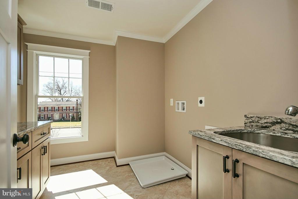 1871 Beulah Road Vienna, VA 22182 - Photo 21 of 30 a bathroom with a sink a toilet and a window