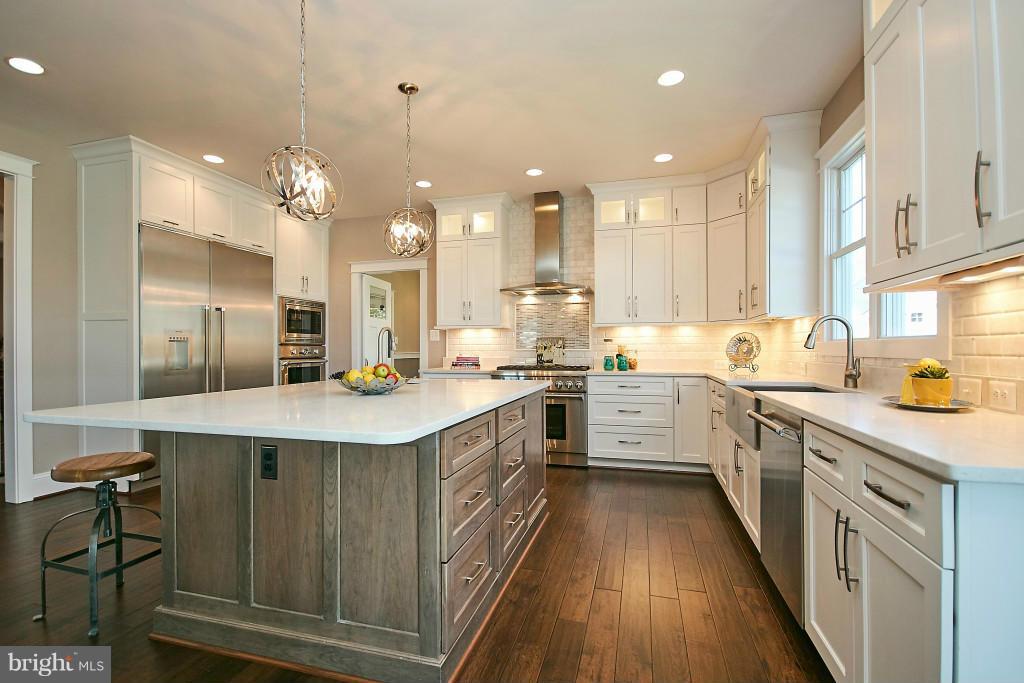 1871 Beulah Road Vienna, VA 22182 - Photo 6 of 30 a kitchen with kitchen island a sink a counter top space stainless steel appliances and cabinets