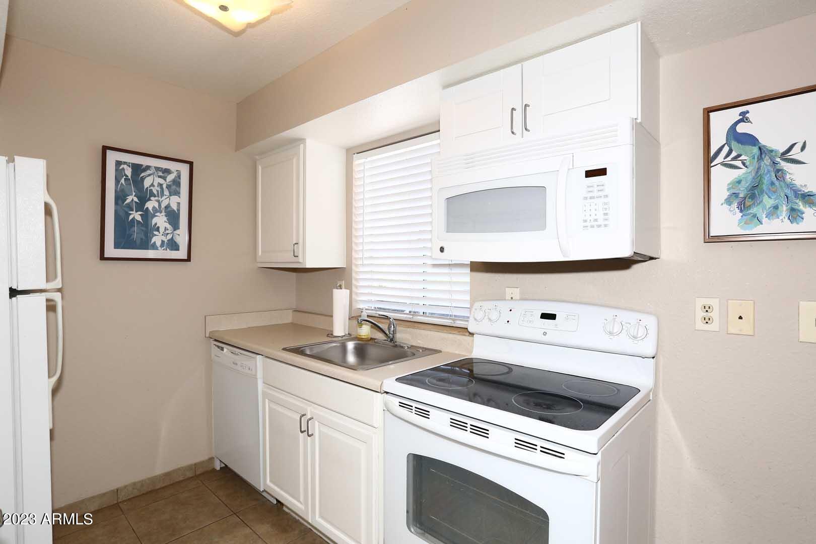 4554 East Paradise Village Parkway North, Unit 259 Phoenix, AZ 85032 - Photo 11 of 30 a utility room with dryer and washer