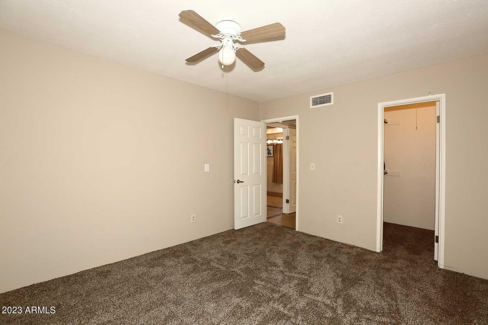 4554 East Paradise Village Parkway North, Unit 259 Phoenix, AZ 85032 - Photo 14 of 30 a view of a ceiling fan in a room