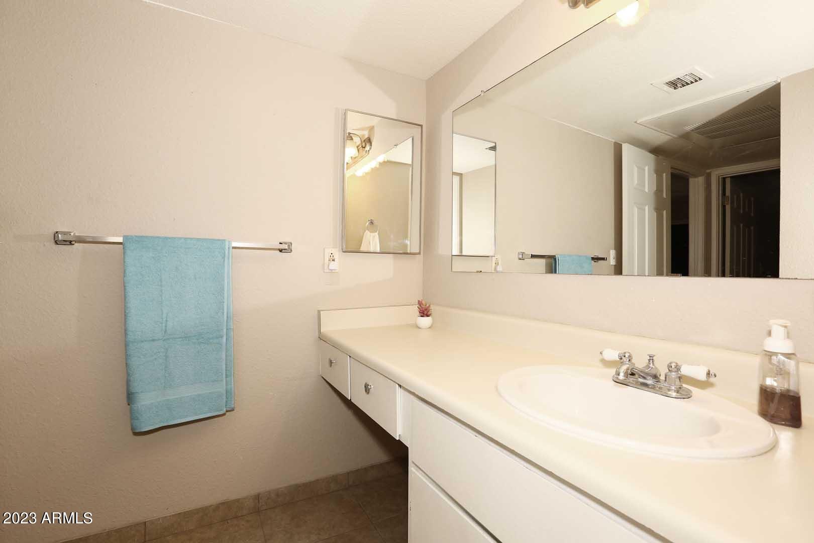 4554 East Paradise Village Parkway North, Unit 259 Phoenix, AZ 85032 - Photo 16 of 30 a bathroom with a sink and a mirror