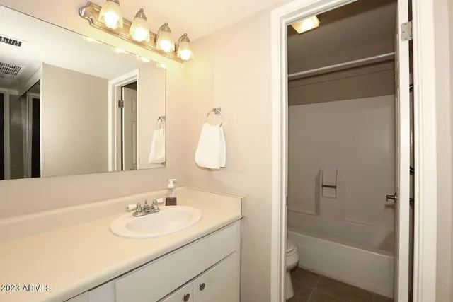 a bathroom with a sink a vanity and shower