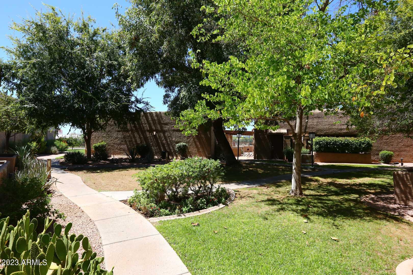 4554 East Paradise Village Parkway North, Unit 259 Phoenix, AZ 85032 - Photo 22 of 30 a backyard of a house with lots of green space