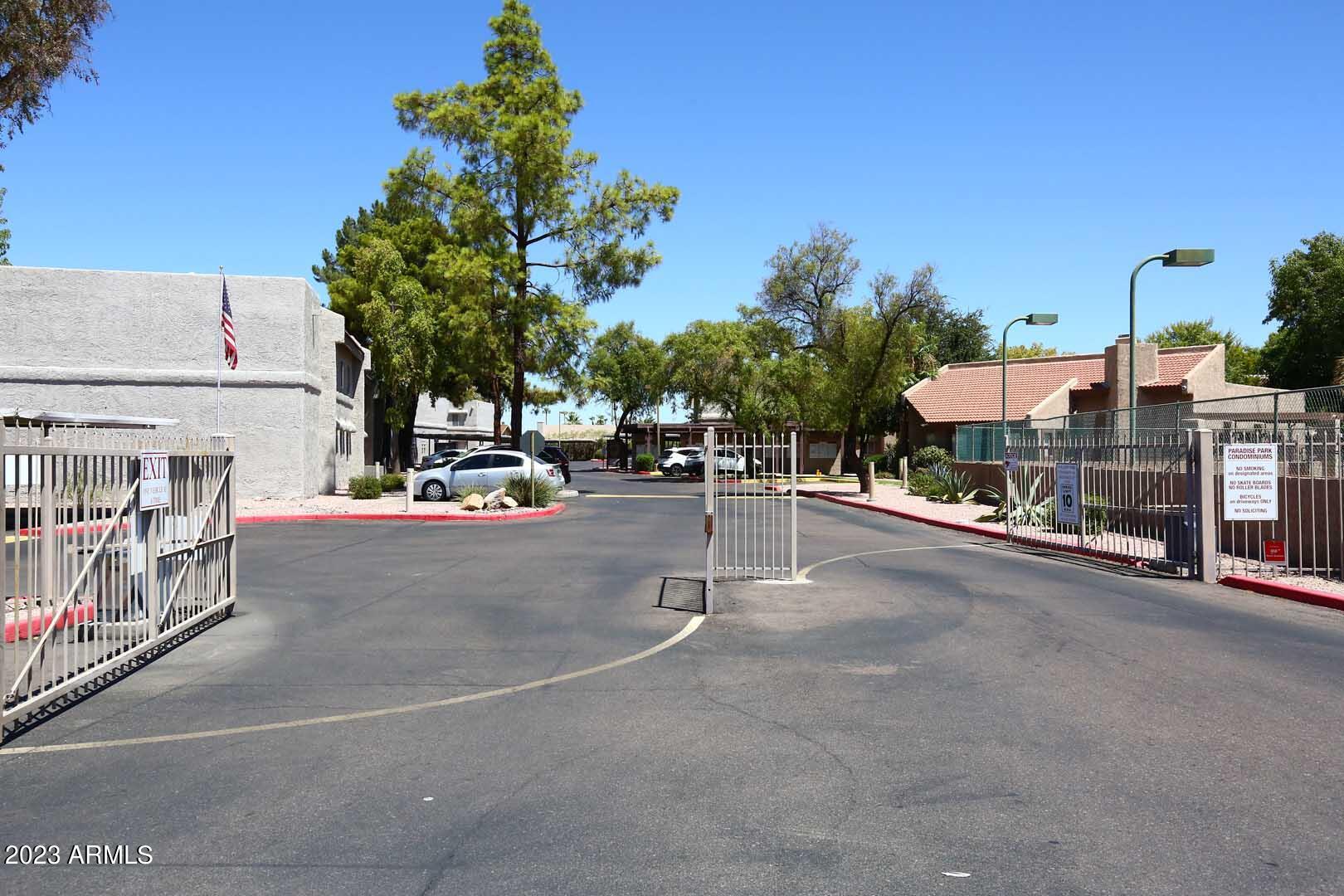 4554 East Paradise Village Parkway North, Unit 259 Phoenix, AZ 85032 - Photo 24 of 30 a view of a street with cars on the road