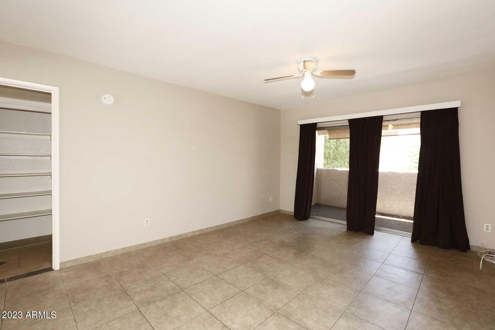 4554 East Paradise Village Parkway North, Unit 259 Phoenix, AZ 85032 - Photo 5 of 30 an empty room with closet and a ceiling fan