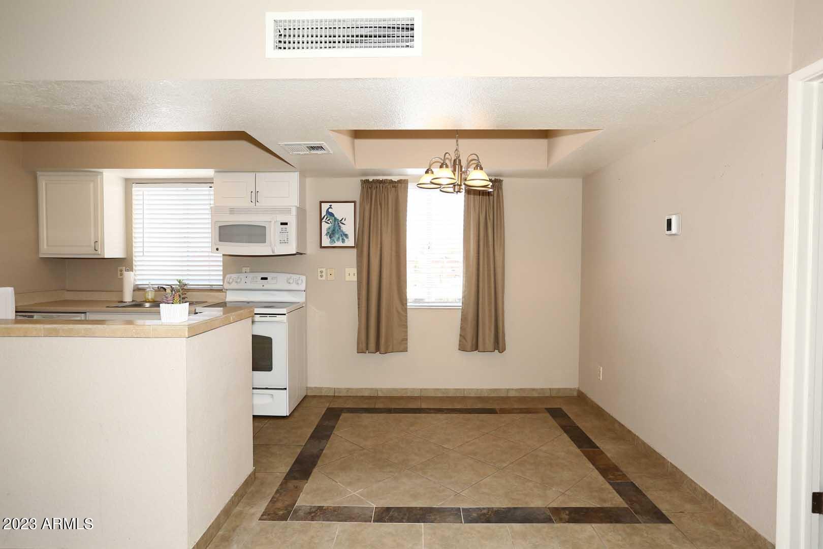 4554 East Paradise Village Parkway North, Unit 259 Phoenix, AZ 85032 - Photo 7 of 30 a bathroom with a sink a vanity and a mirror