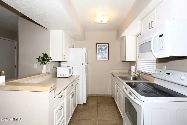 a kitchen that has a sink and a stove