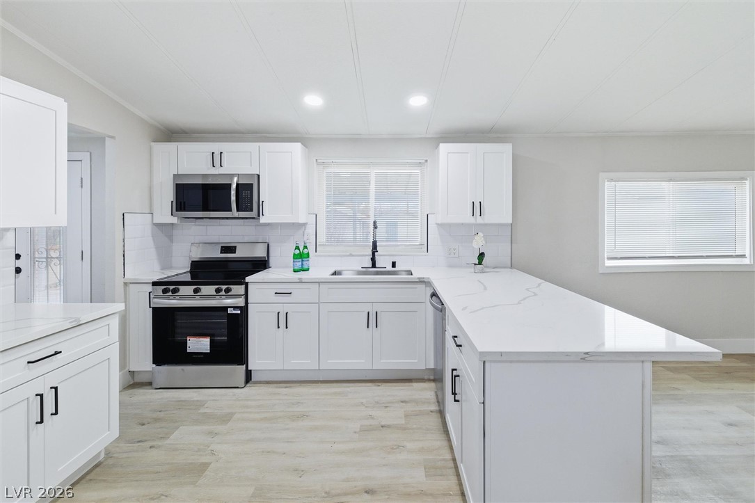3940 Point Drive Pahrump, NV 89060 - Photo 14 of 35 A well-appointed kitchen showcasing elegant quartz countertops and contemporary cabinetry.