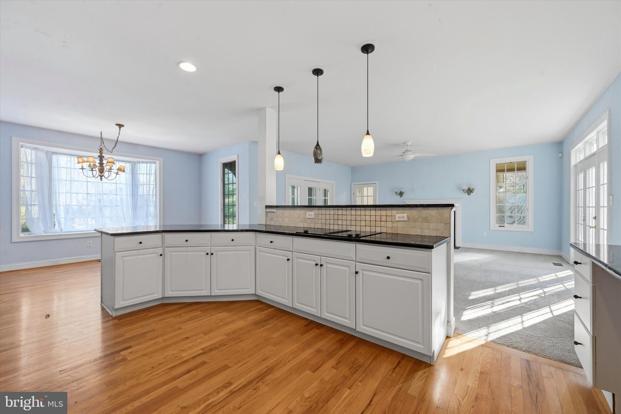 2 Timber Mill Lane Landenberg, PA 19350 - Photo 13 of 32 a large kitchen with kitchen island white cabinets and wooden floor