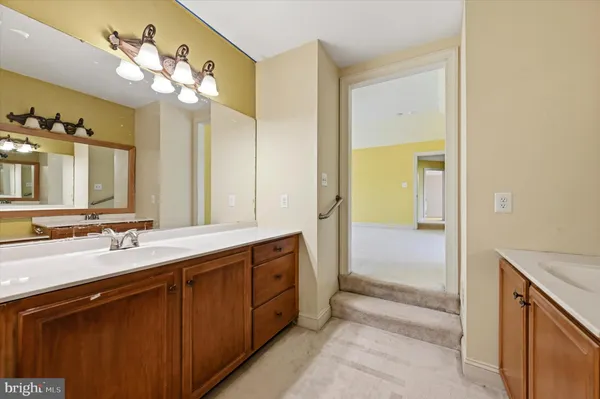 a bathroom with a double vanity sink and a mirror