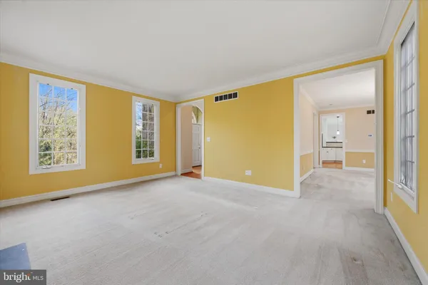 a view of an empty room with glass door
