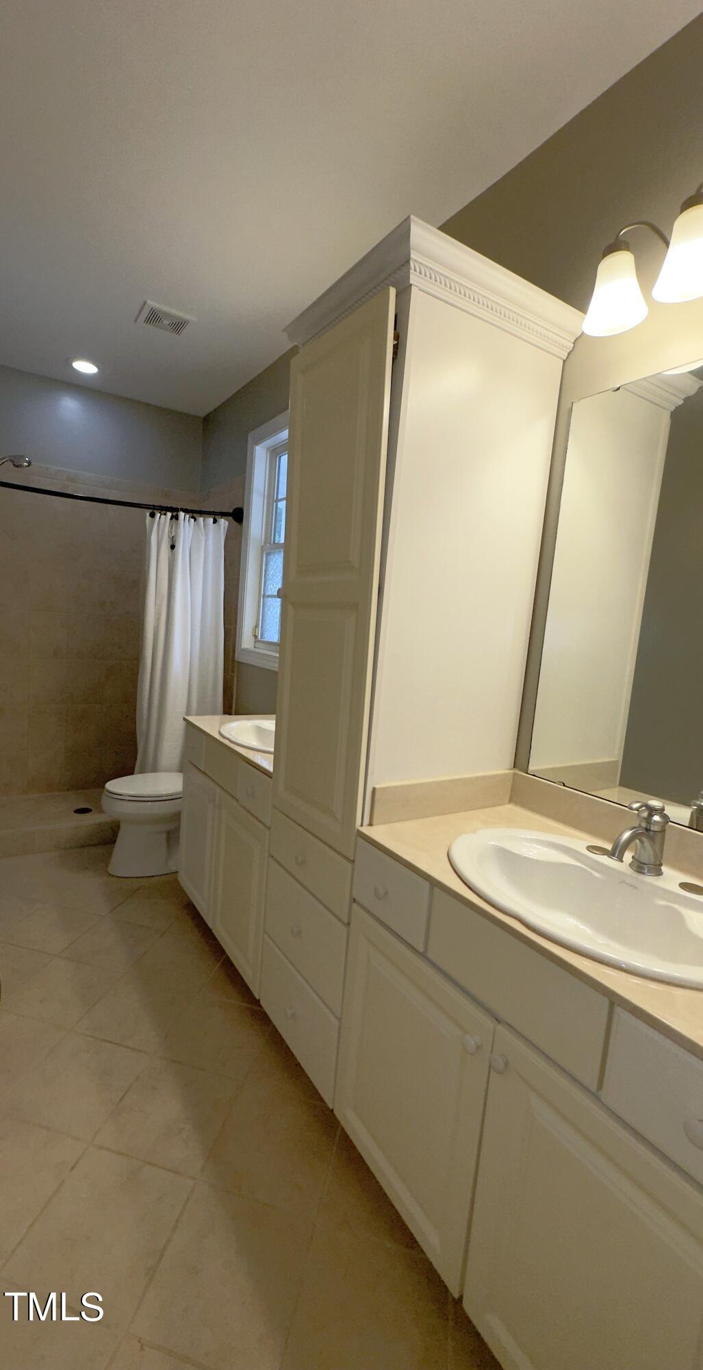 1911 South Mineral Springs Road Durham, NC 27703 - Photo 12 of 31 a bathroom with a sink and a mirror