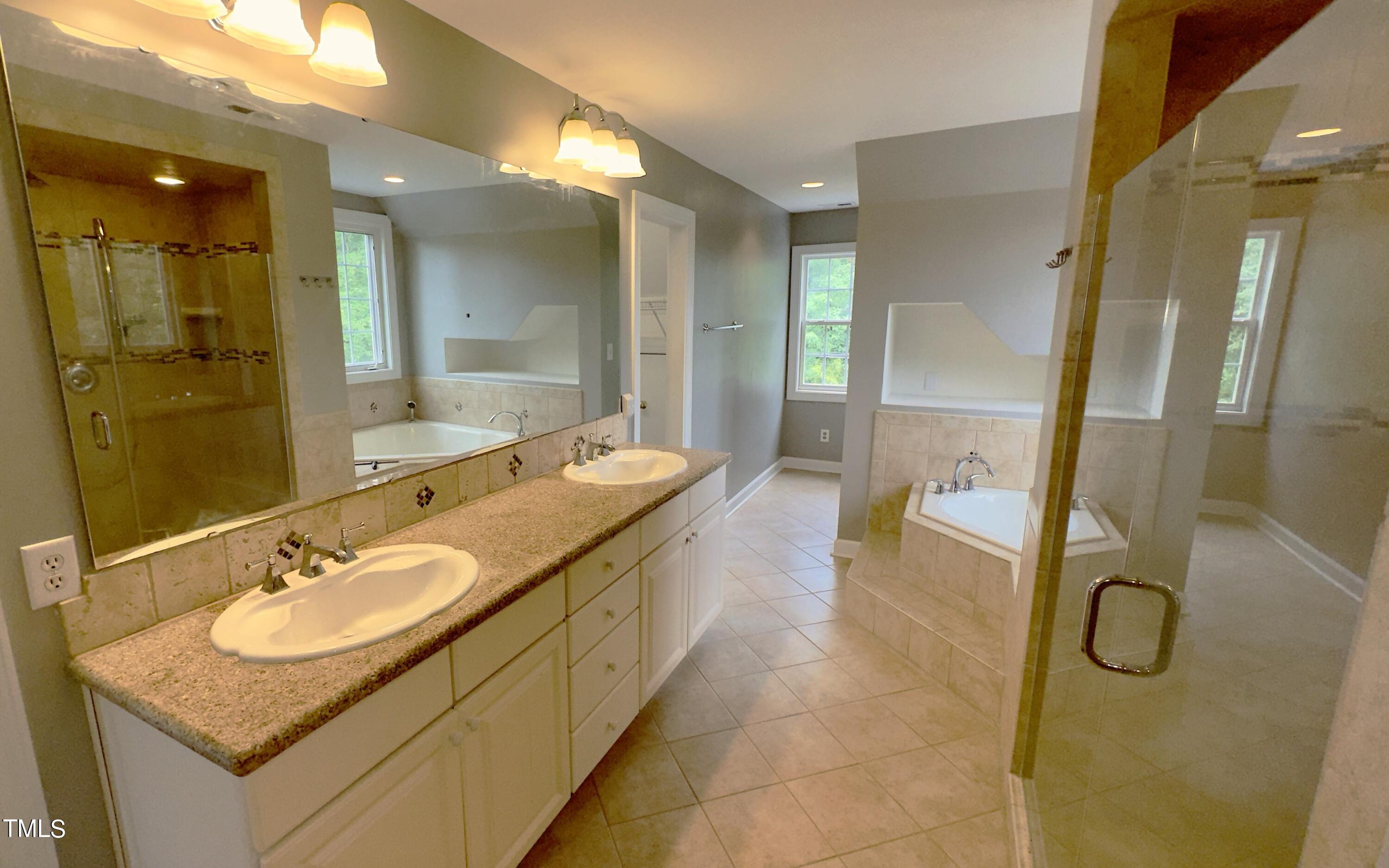 1911 South Mineral Springs Road Durham, NC 27703 - Photo 16 of 31 a bathroom with a granite countertop sink mirror and shower