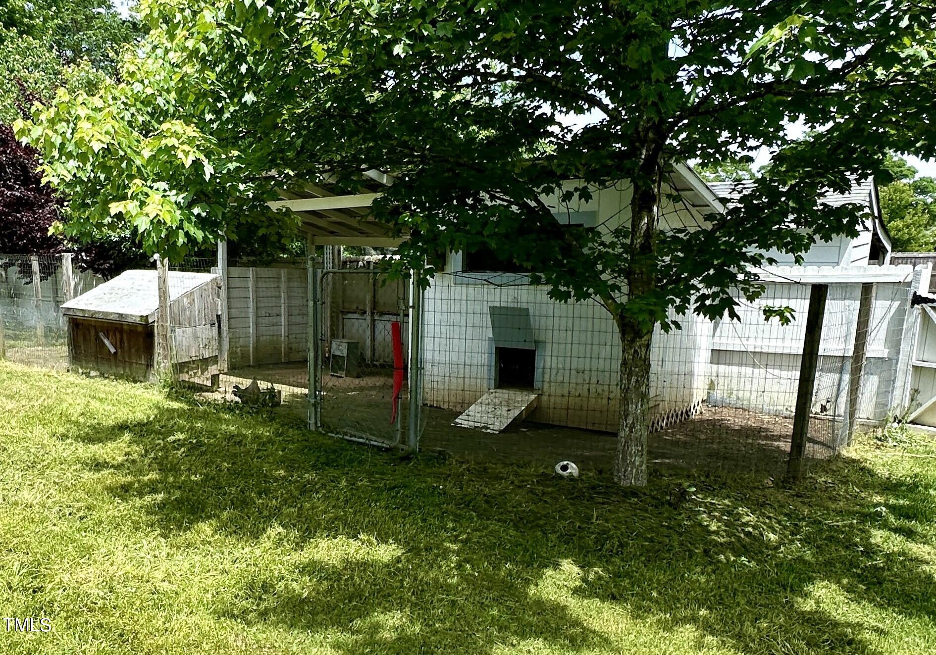 1911 South Mineral Springs Road Durham, NC 27703 - Photo 22 of 31 a view of a backyard with a tree