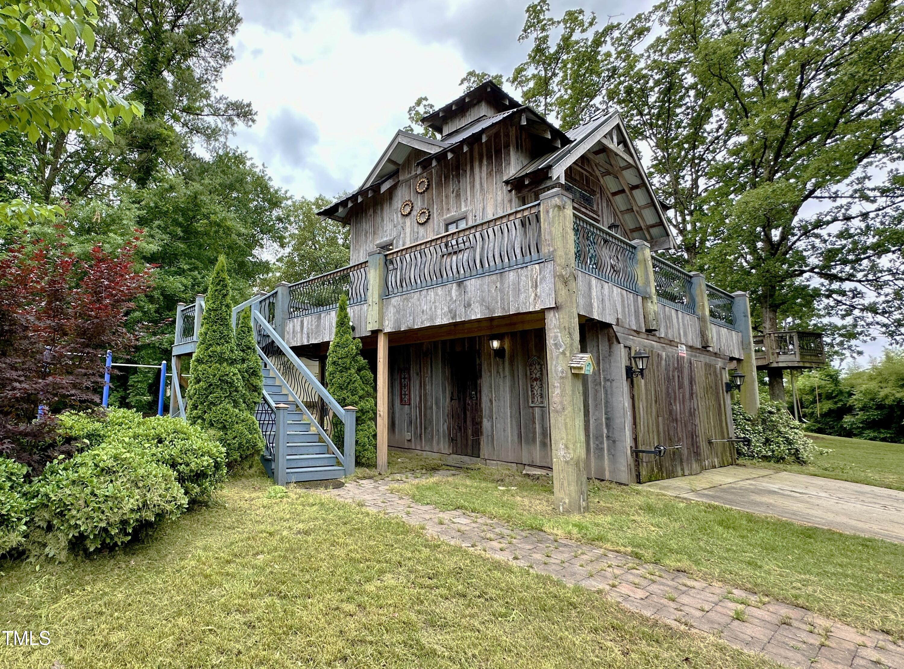 1911 South Mineral Springs Road Durham, NC 27703 - Photo 25 of 31 a view of a house with wooden fence and a large tree