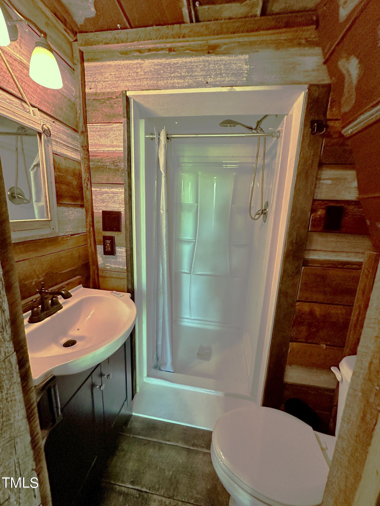1911 South Mineral Springs Road Durham, NC 27703 - Photo 30 of 31 a bathroom with a sink toilet and shower