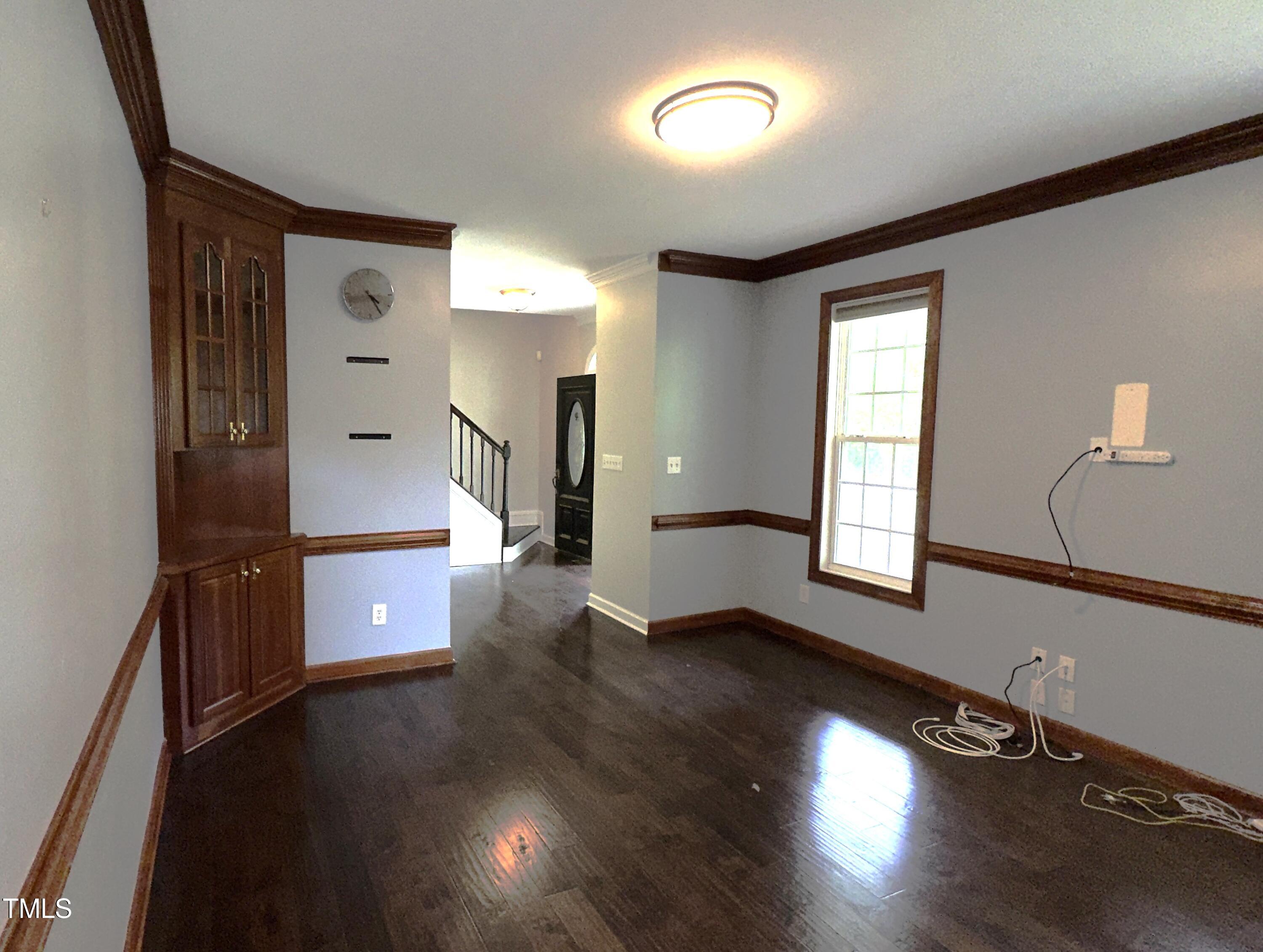 1911 South Mineral Springs Road Durham, NC 27703 - Photo 4 of 31 an empty room with wooden floor and windows