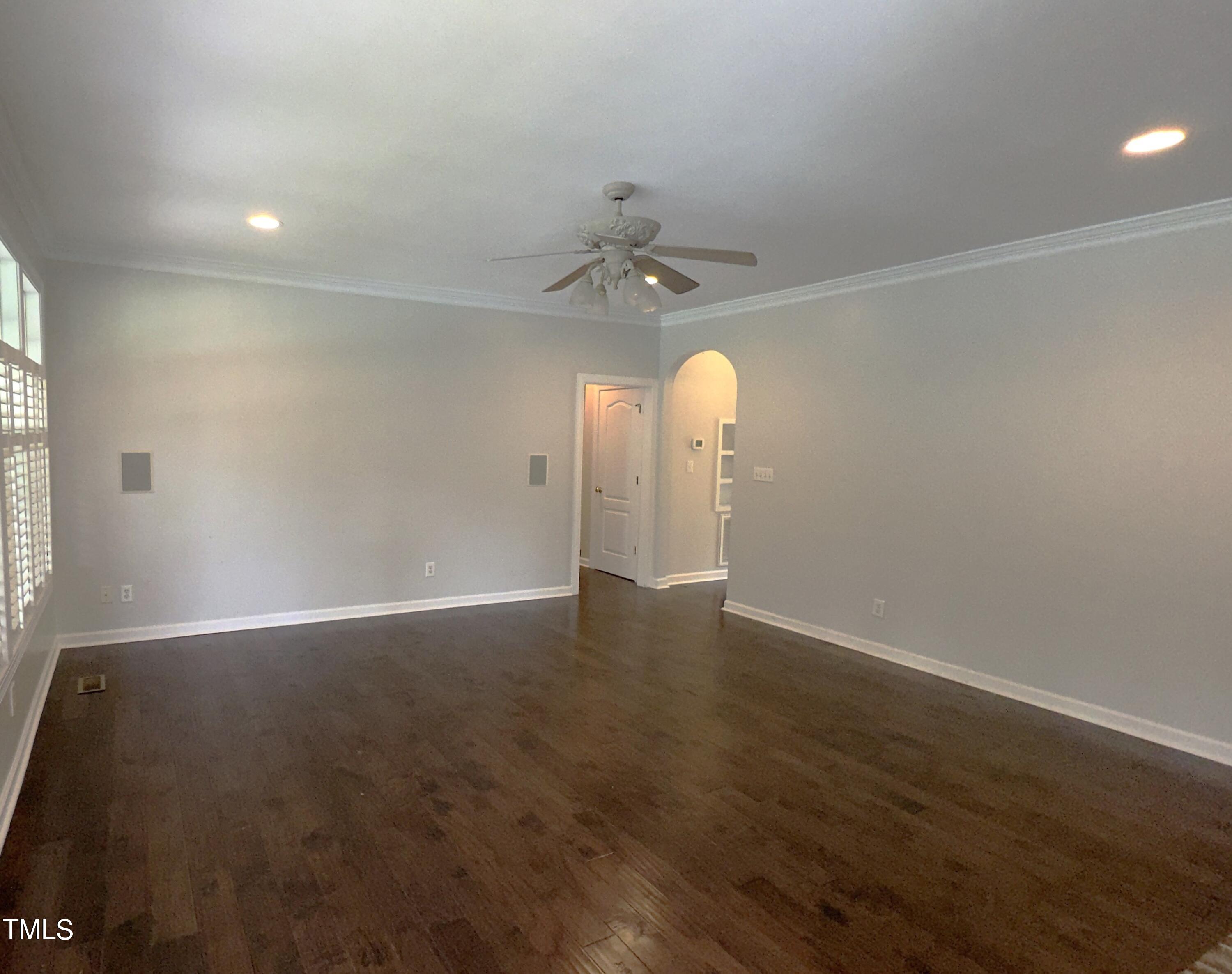 1911 South Mineral Springs Road Durham, NC 27703 - Photo 7 of 31 an empty room with wooden floor and fan