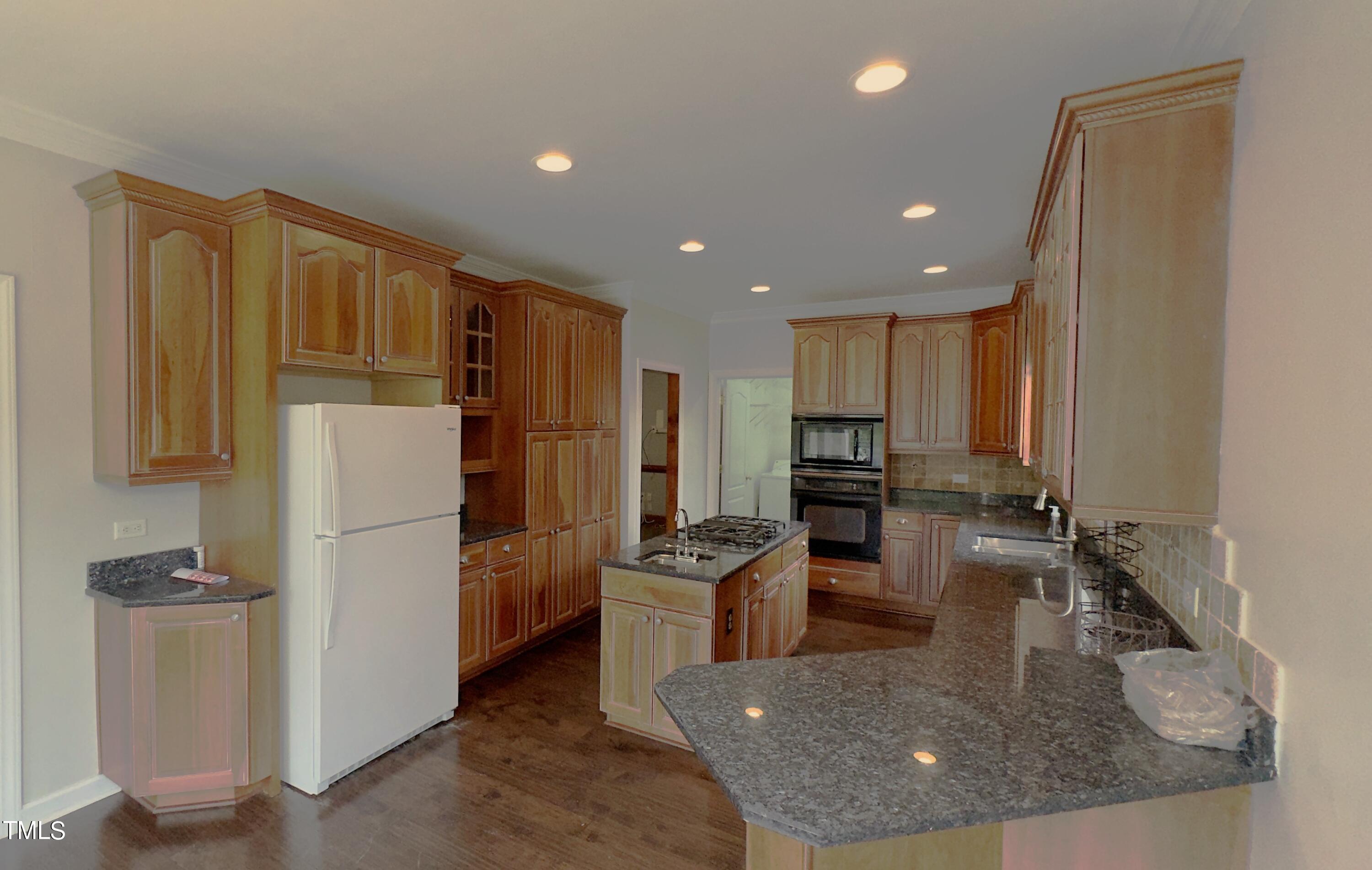 1911 South Mineral Springs Road Durham, NC 27703 - Photo 8 of 31 a kitchen with refrigerator and cabinets