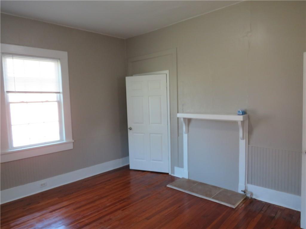 293 4th Street Cedartown, GA 30125 - Photo 11 of 15 an empty room with wooden floor closet and windows