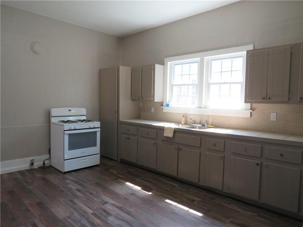 293 4th Street Cedartown, GA 30125 - Photo 13 of 15 a kitchen with sink a microwave and wooden floor