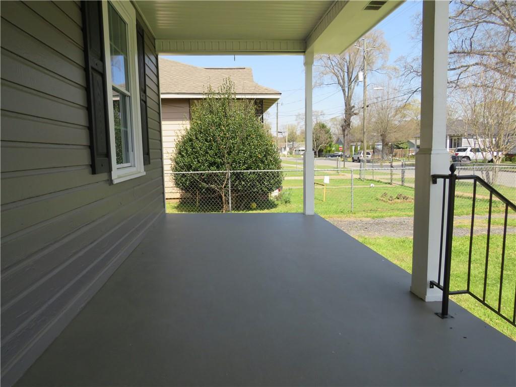 293 4th Street Cedartown, GA 30125 - Photo 5 of 15 a view of a balcony with floor to ceiling windows with wooden floor