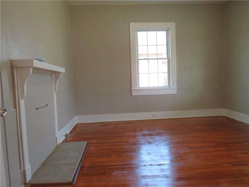 293 4th Street Cedartown, GA 30125 - Photo 7 of 15 a view of an empty room with wooden floor and a window