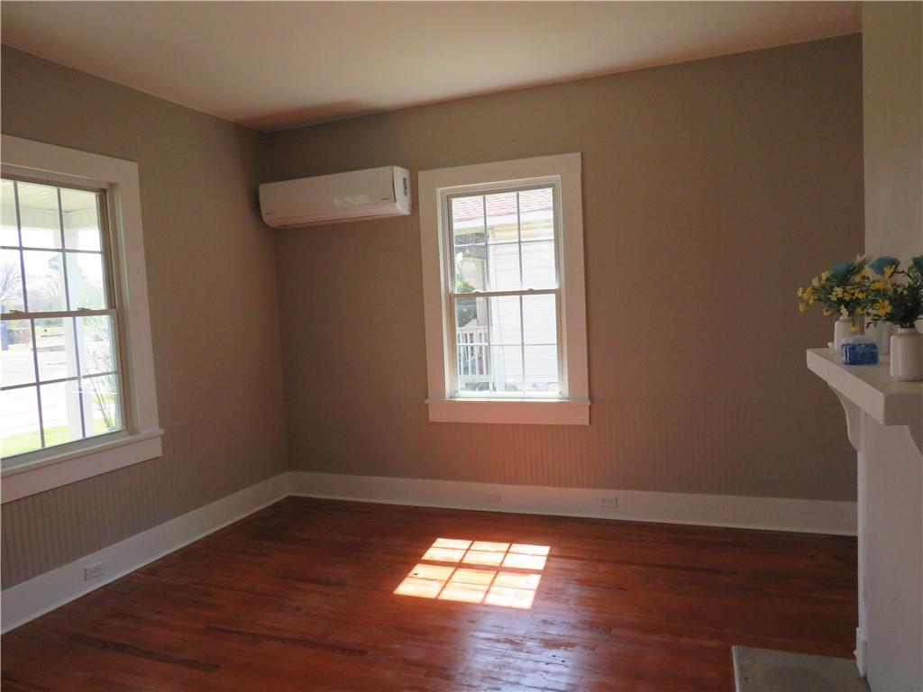 293 4th Street Cedartown, GA 30125 - Photo 9 of 15 an empty room with wooden floor and windows