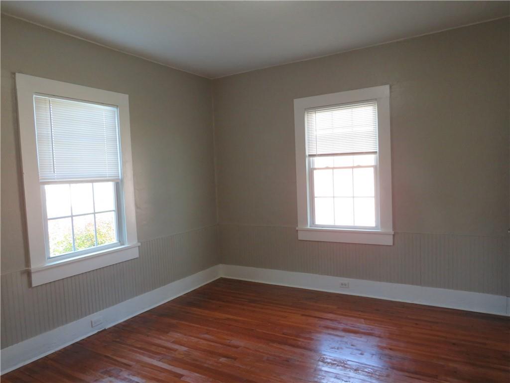 293 4th Street Cedartown, GA 30125 - Photo 10 of 15 an empty room with wooden floor and windows