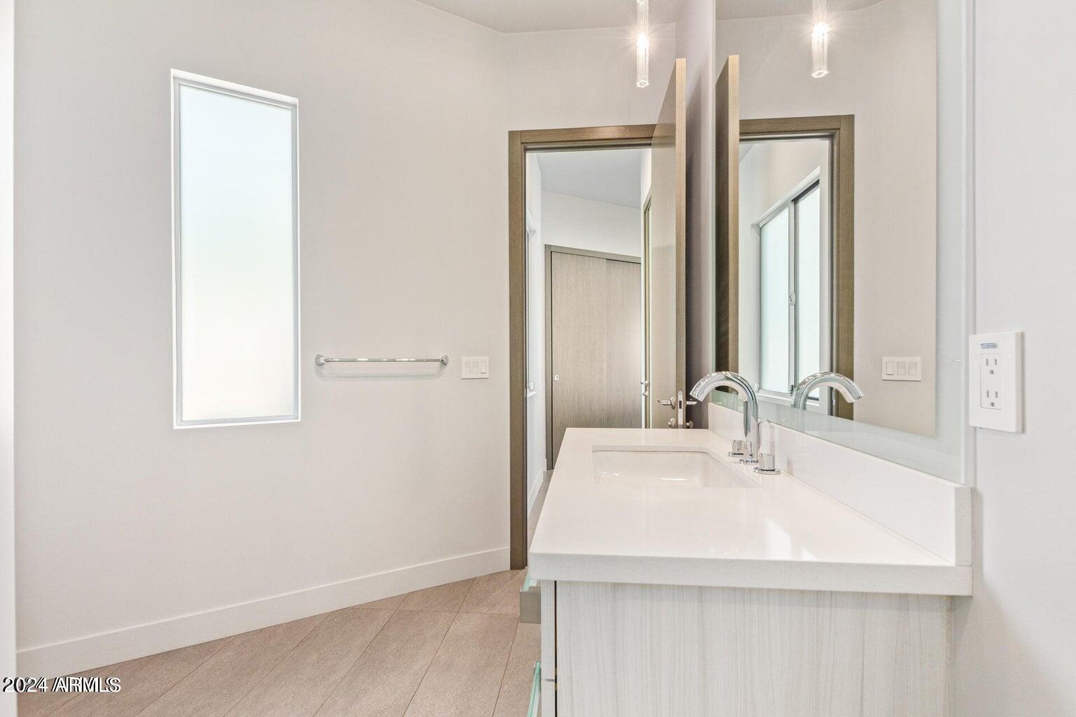 5833 North 46th Street Phoenix, AZ 85018 - Photo 22 of 29 a bathroom with a sink and a mirror