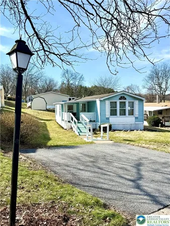 a view of a house with pool and chairs