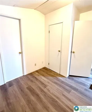 a bathroom with a granite countertop sink and a toilet