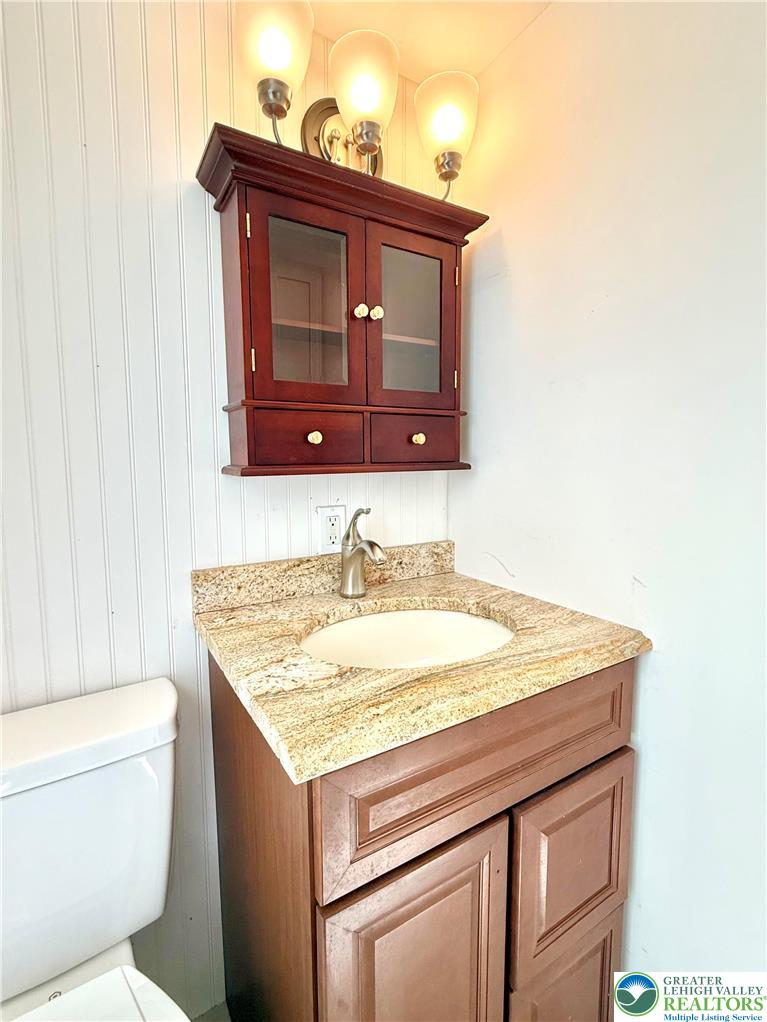 204 Molly Pitcher Road Mount Bethel, PA 18343 - Photo 19 of 34 a bathroom with a granite countertop sink and a toilet