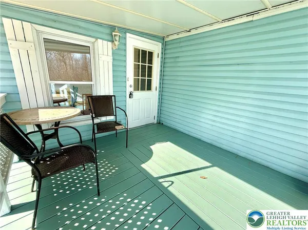 a view of a dining room with furniture and a window
