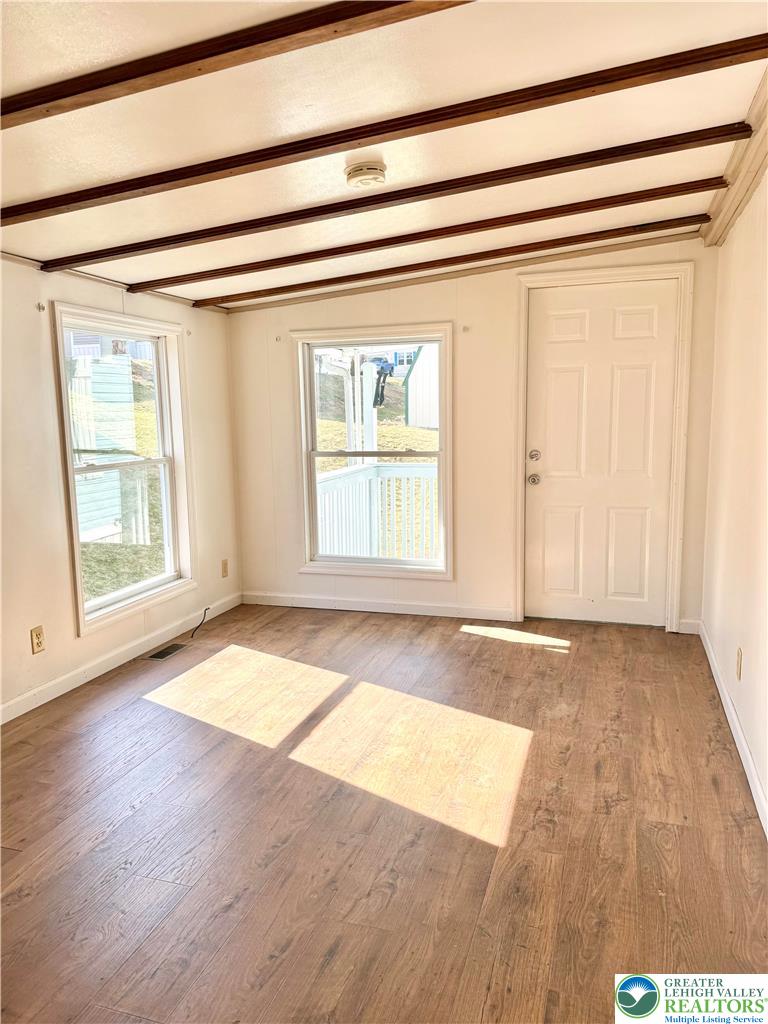 204 Molly Pitcher Road Mount Bethel, PA 18343 - Photo 6 of 34 an empty room with wooden floor and windows