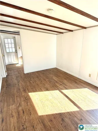a kitchen with stainless steel appliances granite countertop a sink cabinets and wooden floors