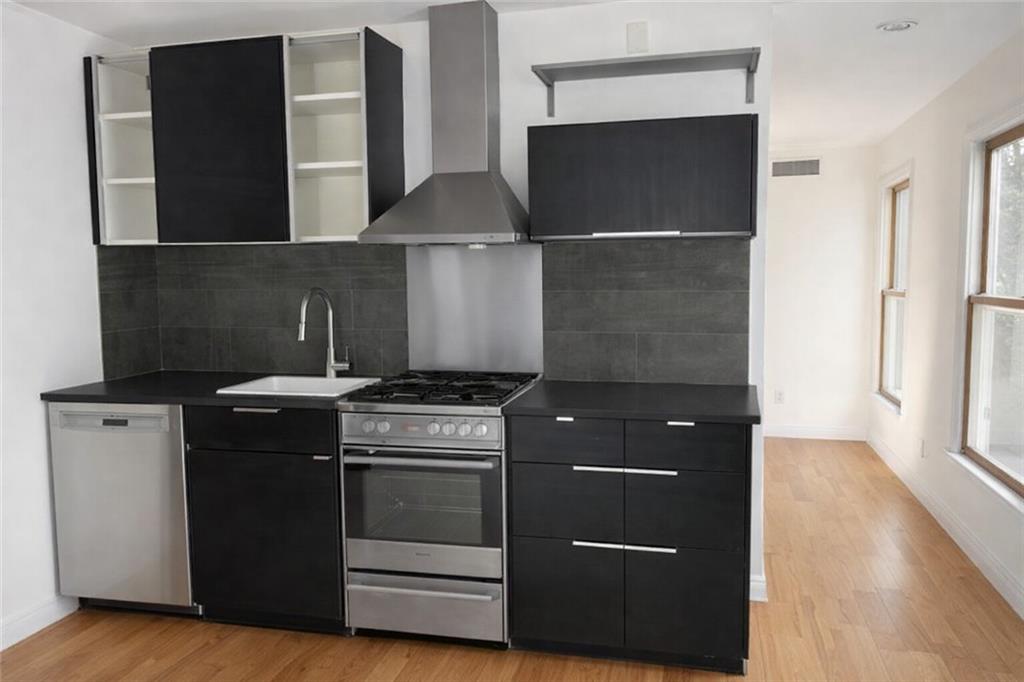 566 Rankin Street Northeast, Unit B Atlanta, GA 30308 - Photo 2 of 5 a kitchen with a stove and a refrigerator
