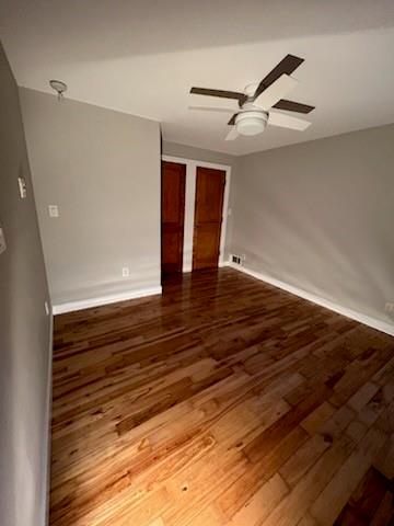 566 Rankin Street Northeast, Unit B Atlanta, GA 30308 - Photo 5 of 5 a view of an empty room with wooden floor and a ceiling fan