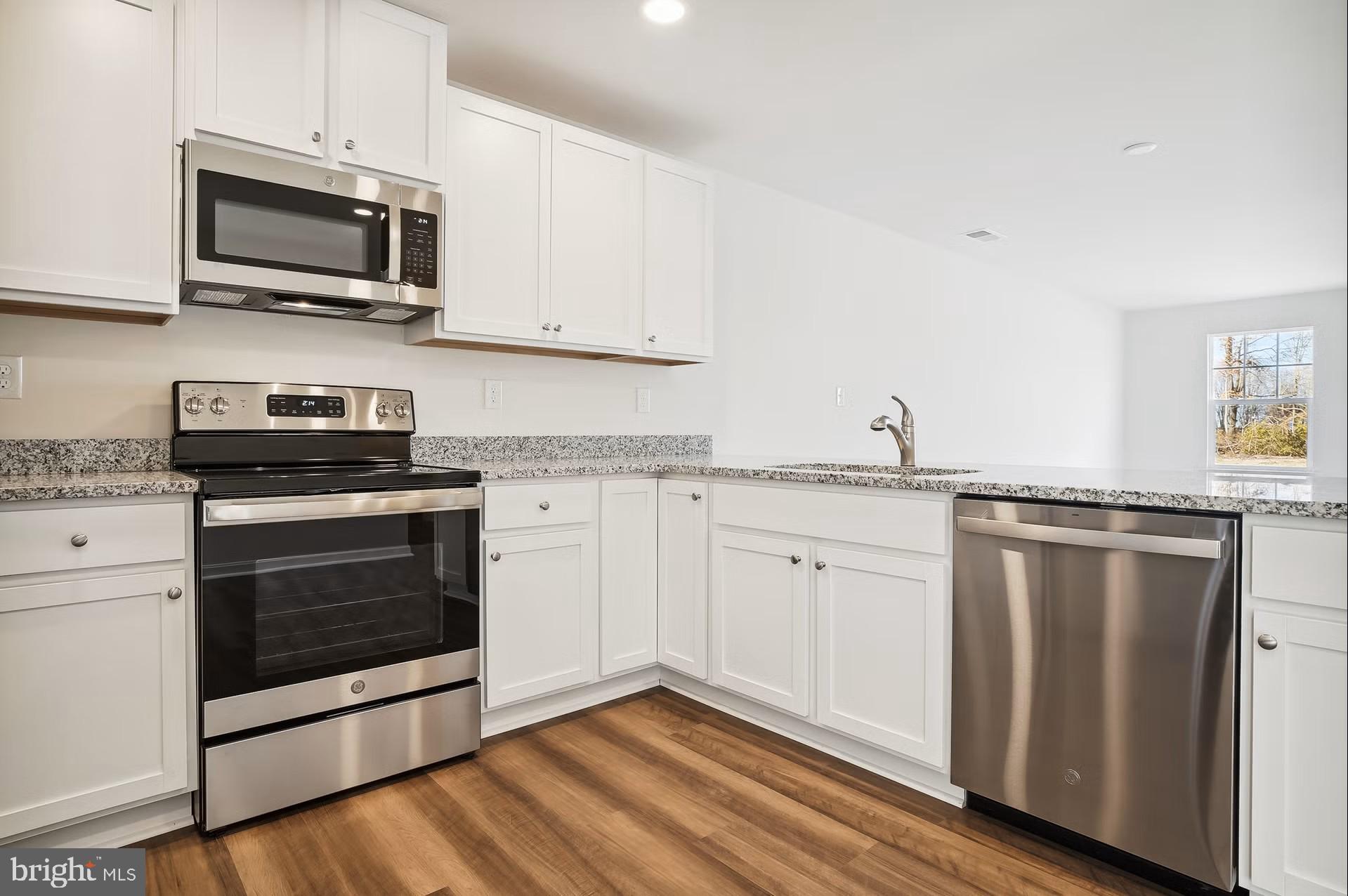 Lot A Lot A Shortly Georgetown, DE 19947 - Photo 3 of 6 a kitchen with granite countertop cabinets stainless steel appliances and wooden floor