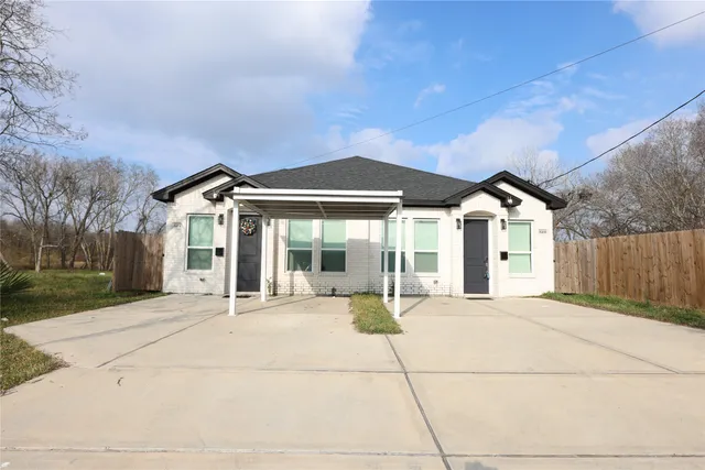a patio with a table and chairs under an umbrella